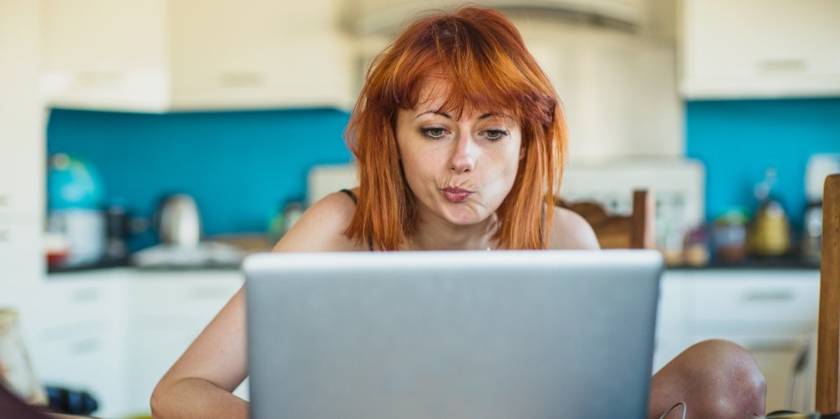 What Is Catfishing? 3 Signs You're Being Catfished woman using a laptop