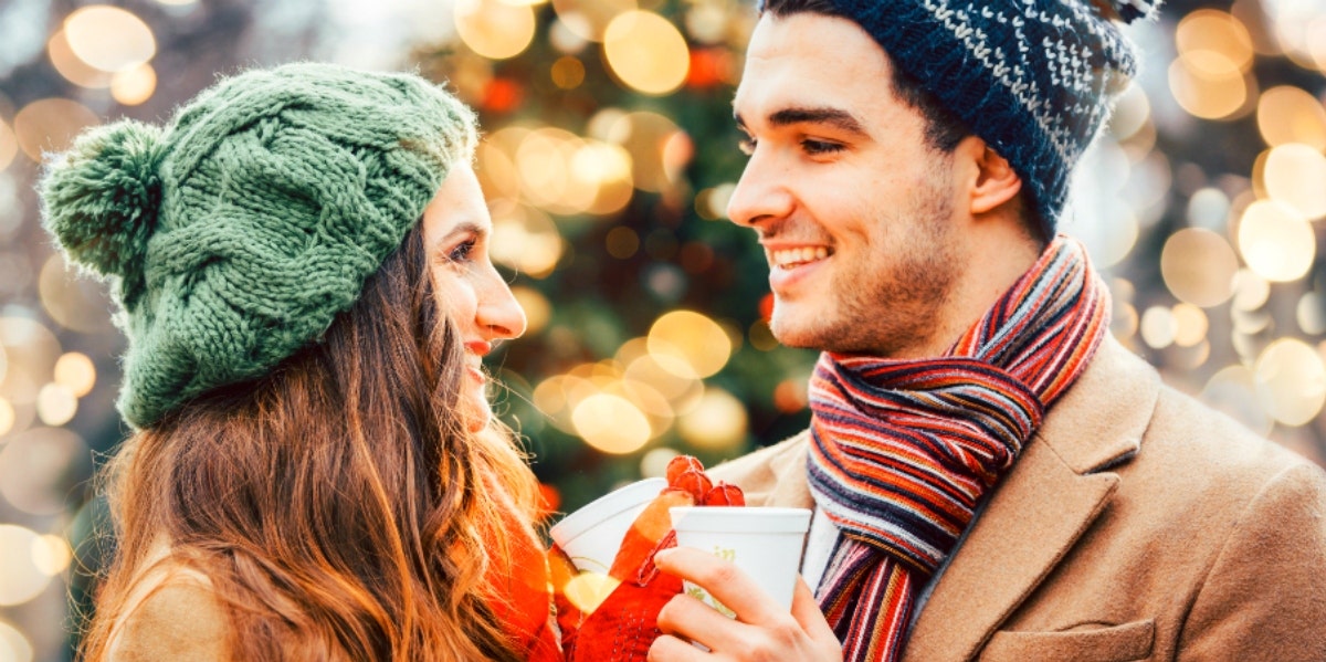 What & When Is Cuffing Season? How To Manage Seasonal Relationships man and woman in winter hats toasting cups