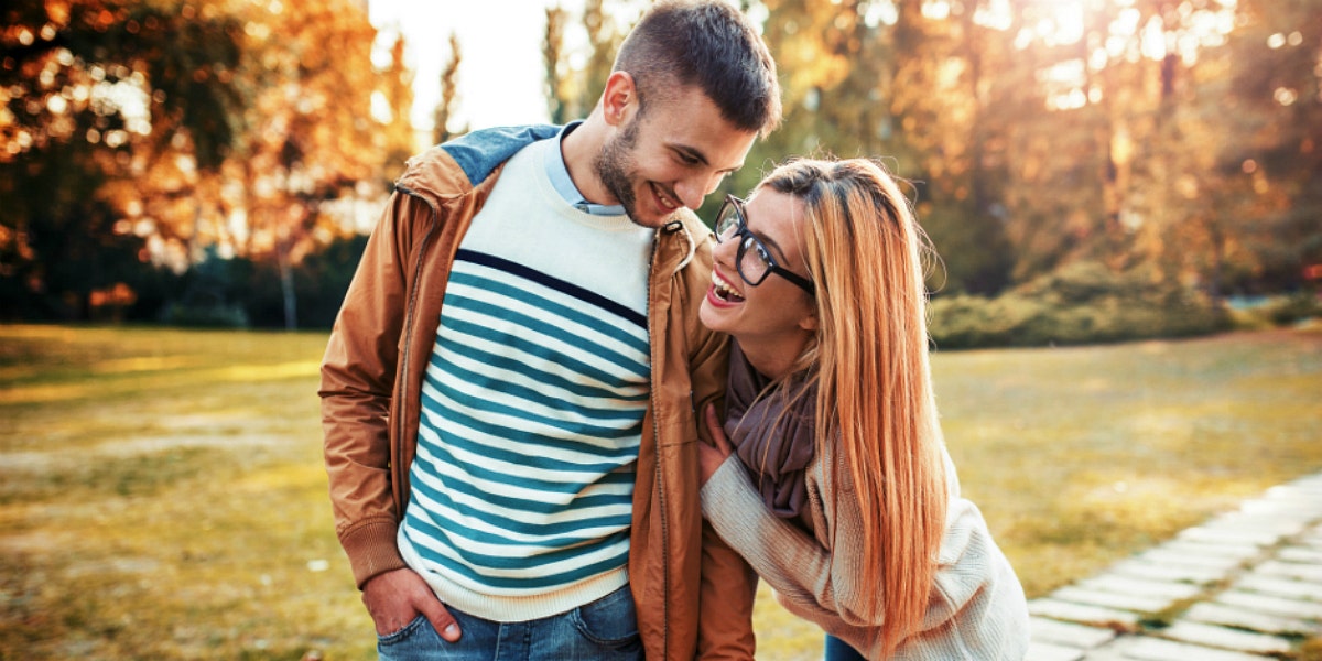 couple holding hands and walking during cuffing season