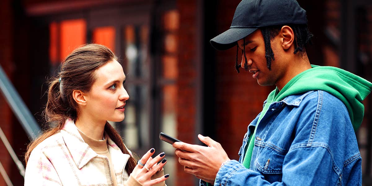 woman and man texting on phones