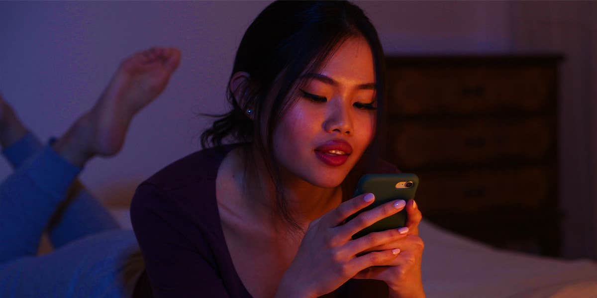 girl texting at night in bed