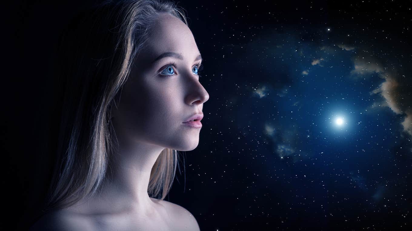 hopeful woman with universe behind her