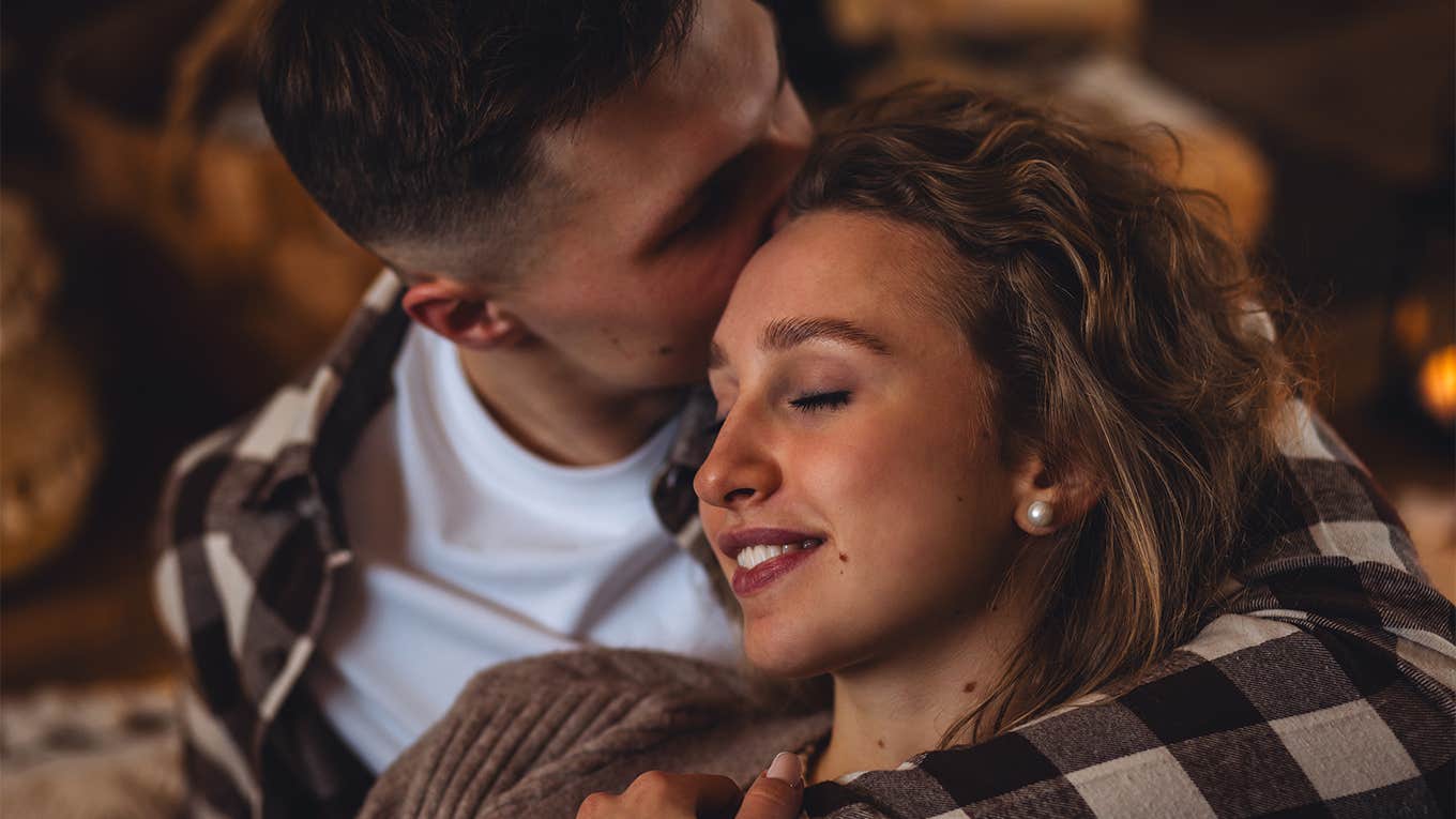 guy kissing girl while cuddling