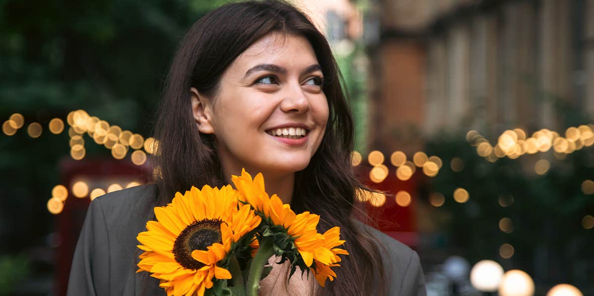 woman holding sunflower