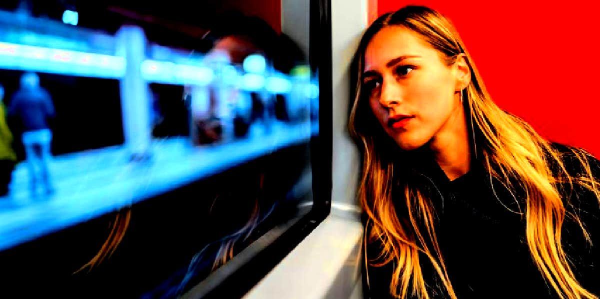 What Is Unrequited Love? 3 Signs & How To Deal With It woman looking out window thinking about unrequited love