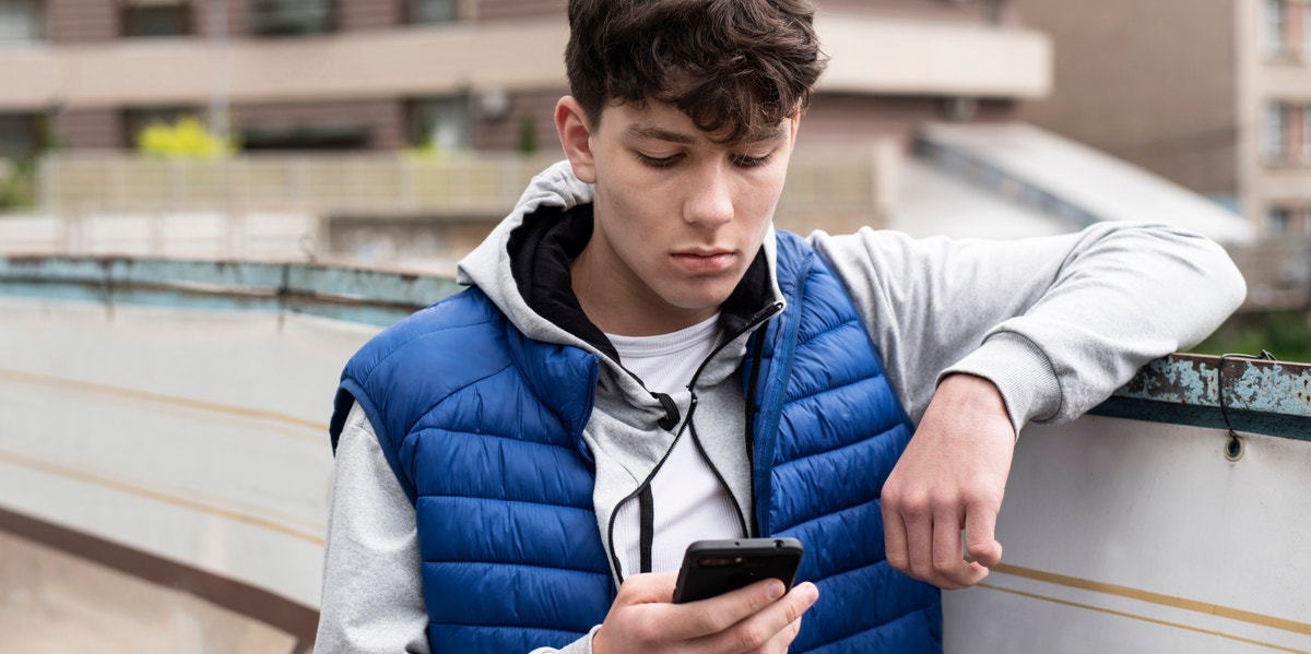 boy looking at iphone