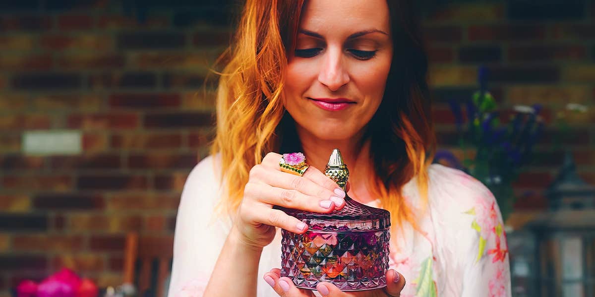 woman holding perfume bottle