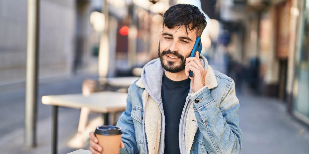 man on phone drinking coffee