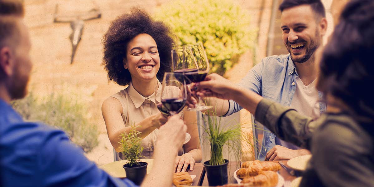 a group of people drinking wine