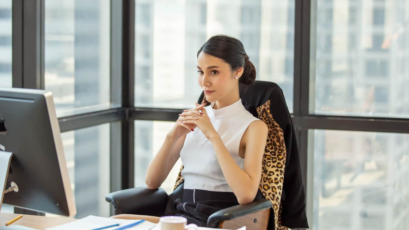 Woman smiling at her desk 