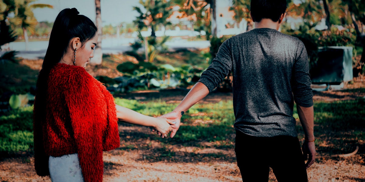 man and woman holding hands