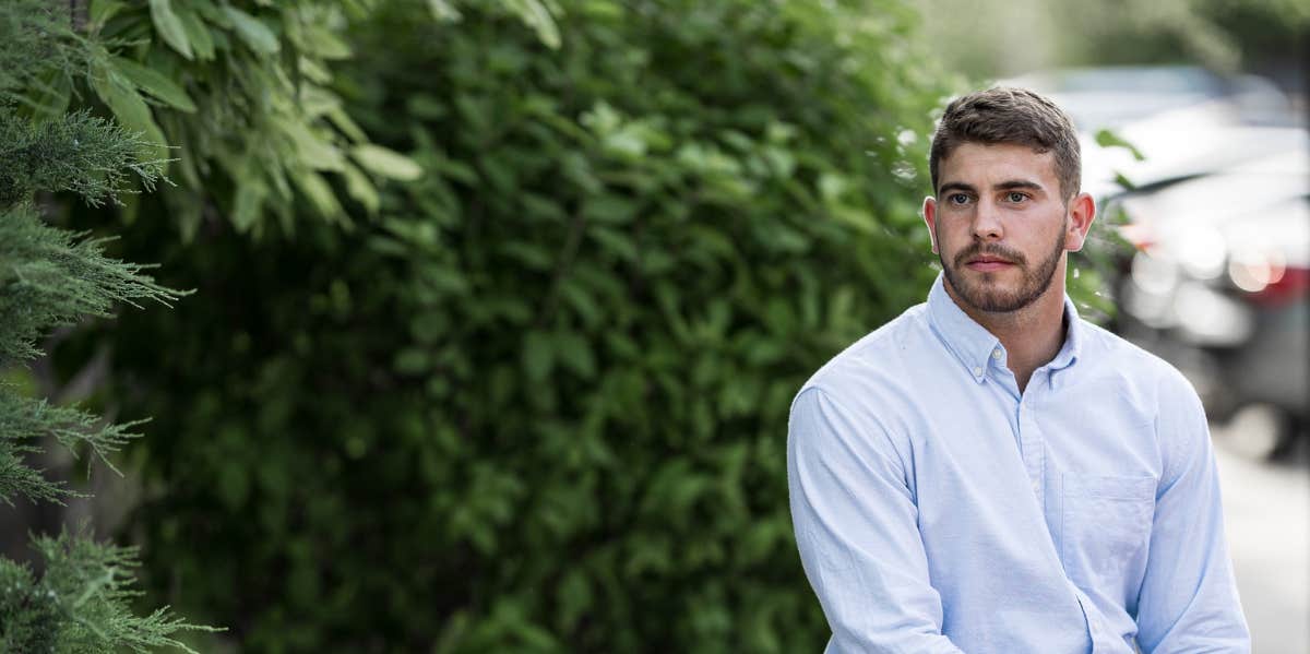 man sitting in greenery