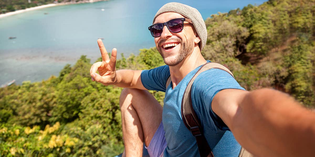 man taking selfie with peace sign
