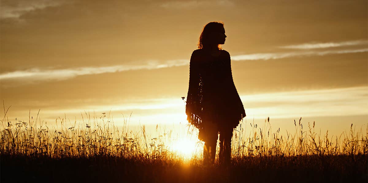 woman standing in sunset