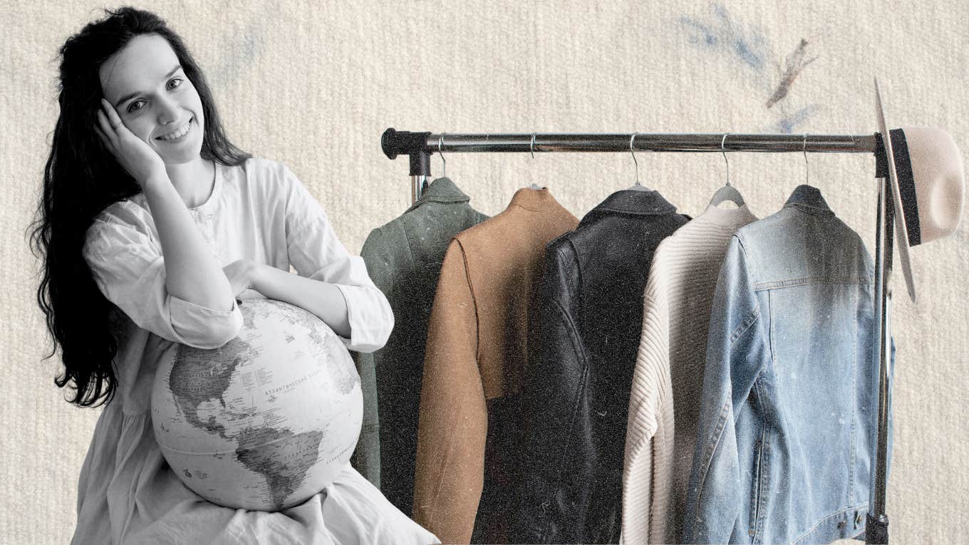 Woman holding a globe in front of a small rack of clothes