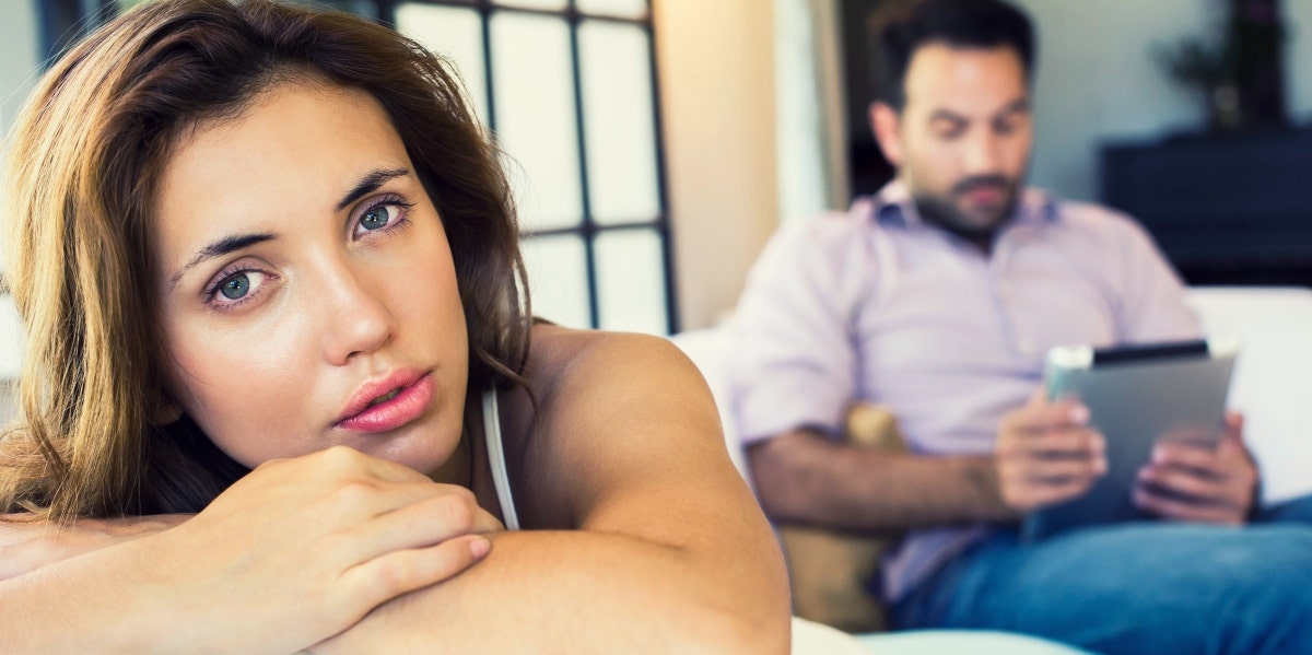 upset woman with man on his ipad