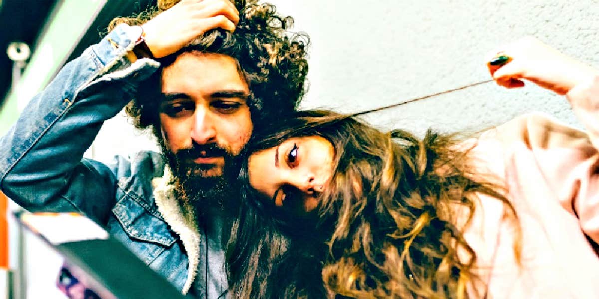 5 Ways A Man's Mother Can Harm A Healthy Relationship brunette couple, each with lots of curly brown hair, looks sad and serious