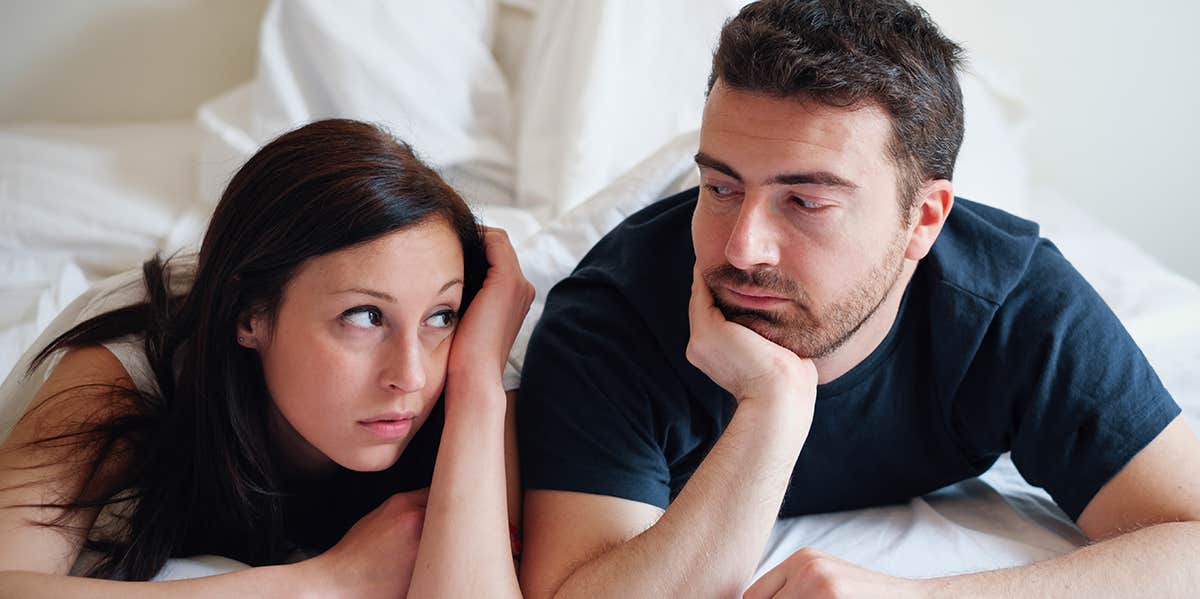 unhappy couple in bed