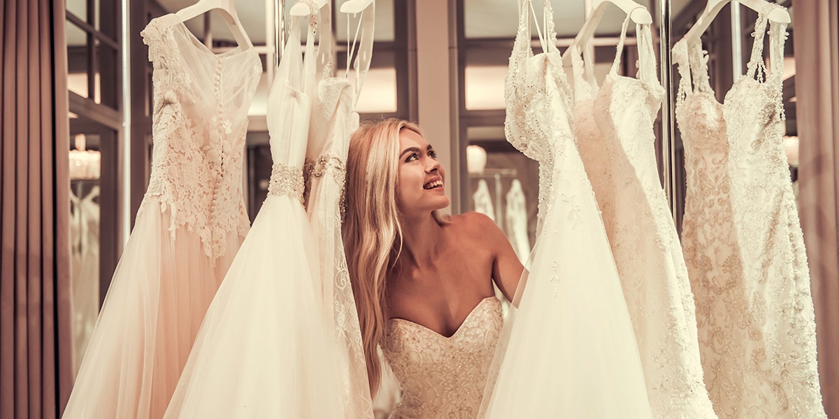 woman in between wedding dresses