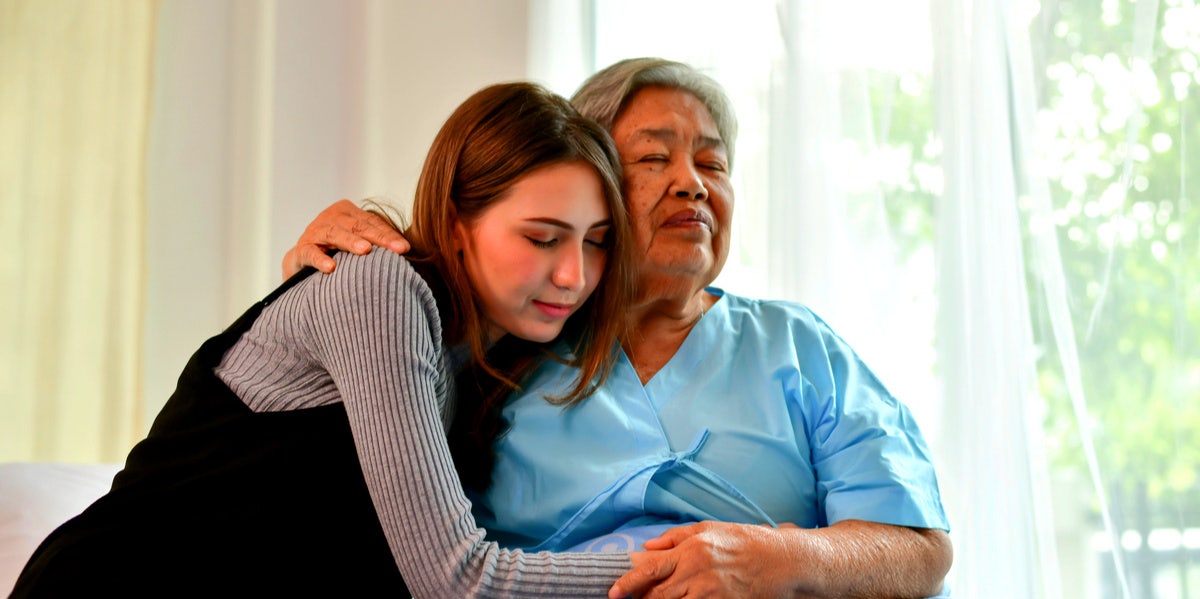 woman comforting someone who is in the hospital