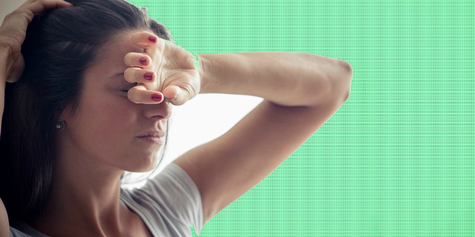 depressed woman with hand covering her forehead