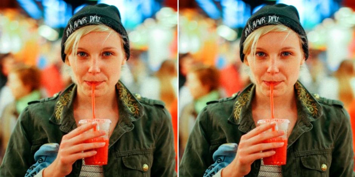 woman in a beanie drinking a smoothie
