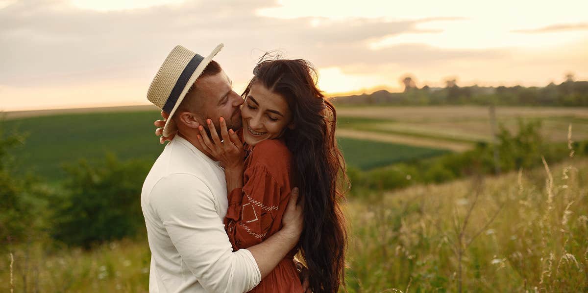 Things We Want In A Partner — But Shouldn't Have To Ask For couple hugging in a field