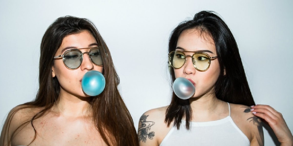 two women chewing bubblegum