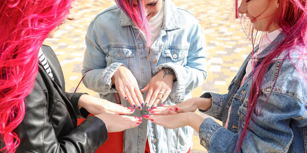 three woman showing off their nails