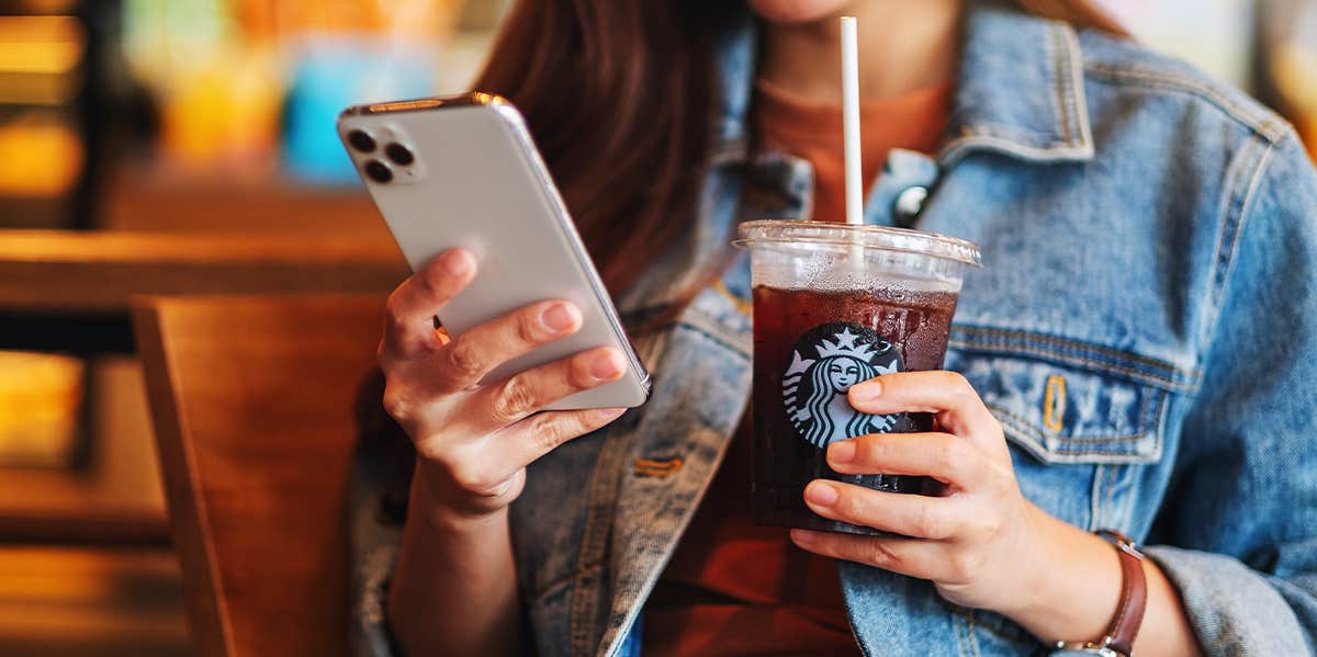 woman holding a starbucks coffee