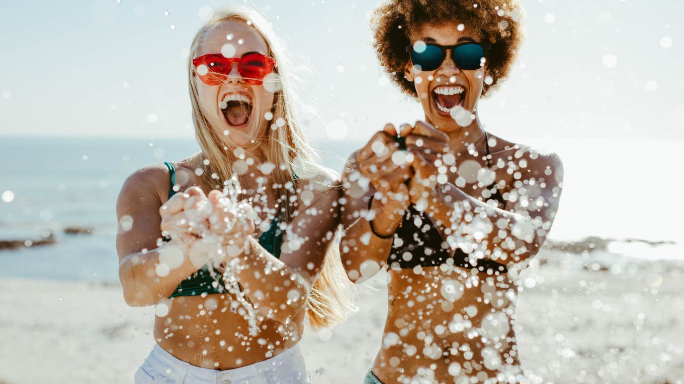 two women splashing in pool