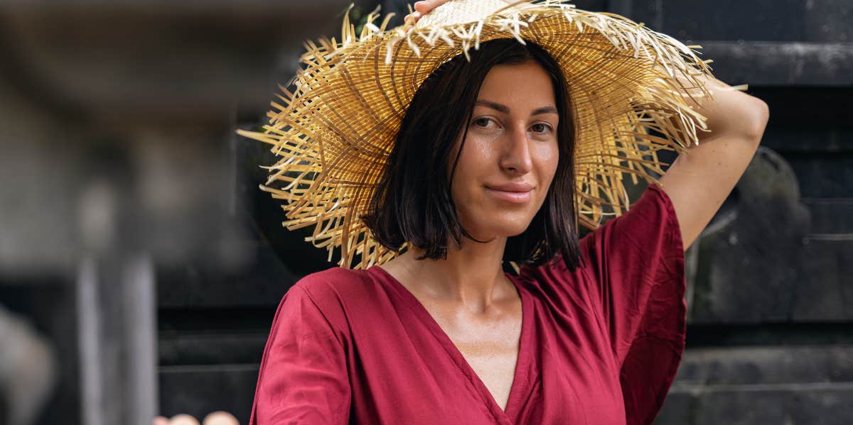 woman in red dress and straw hat