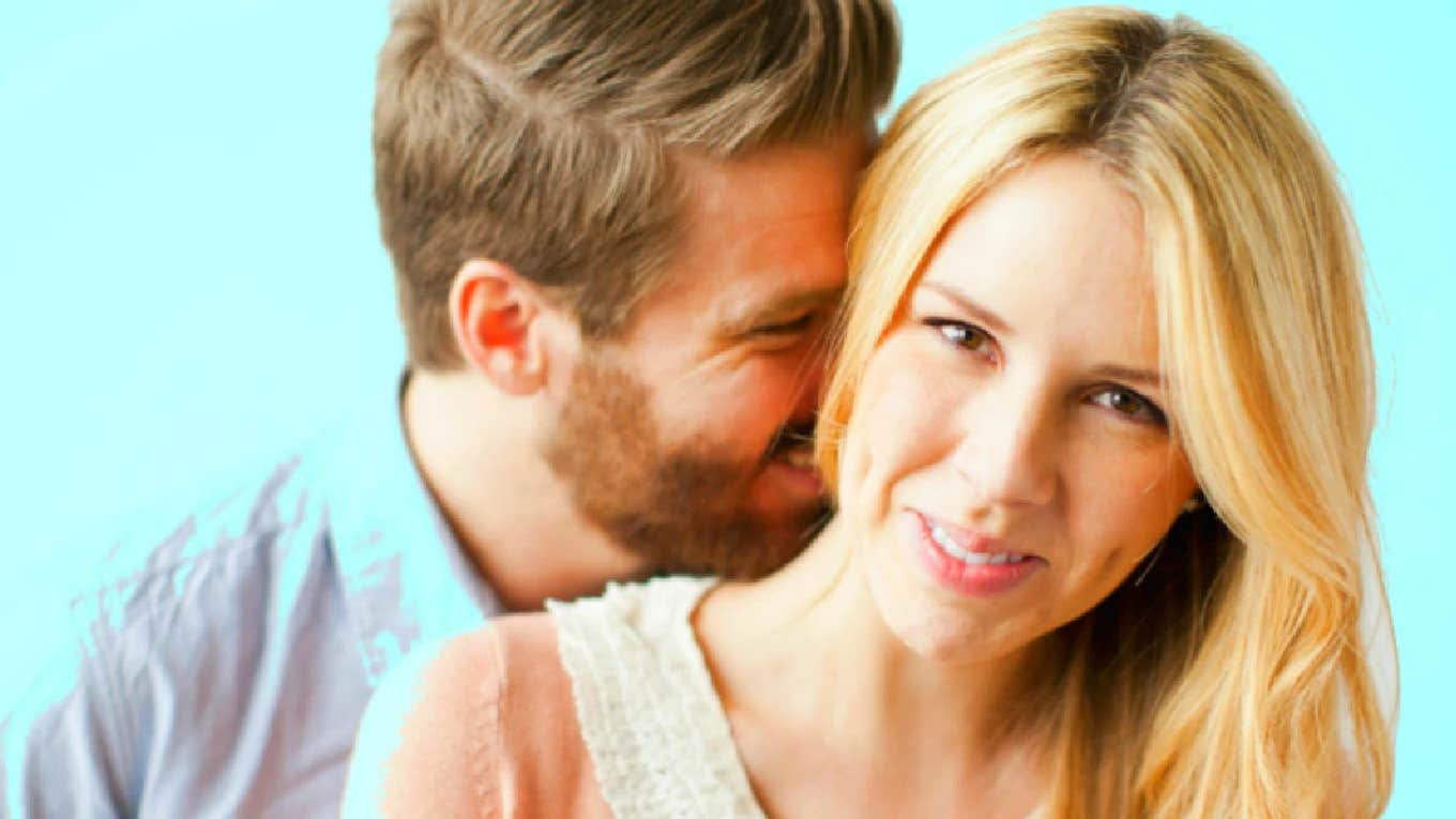 man whispering into a woman's ear