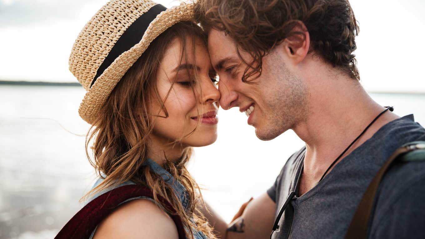 couple touching noses on the beach