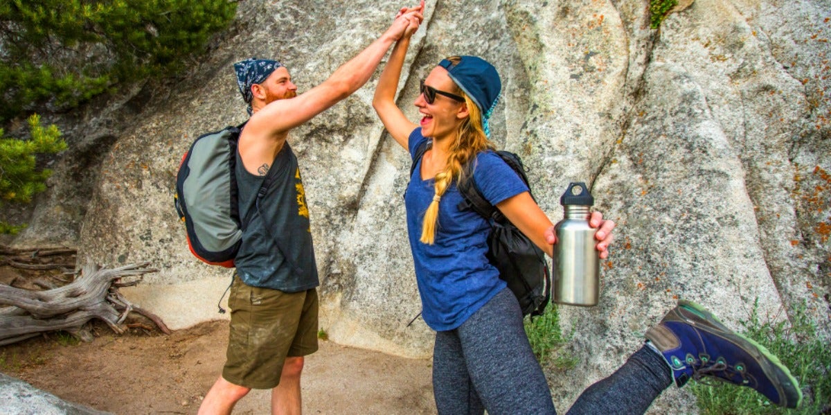 What Does It Mean When A Guy Says He Cares About You? How Men Show Love couple giving each other a high five