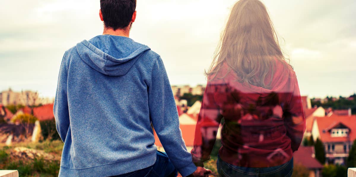 couple holding hands while one fades away in the distance