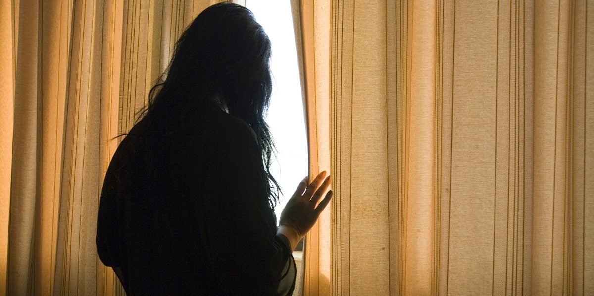 woman looking out window