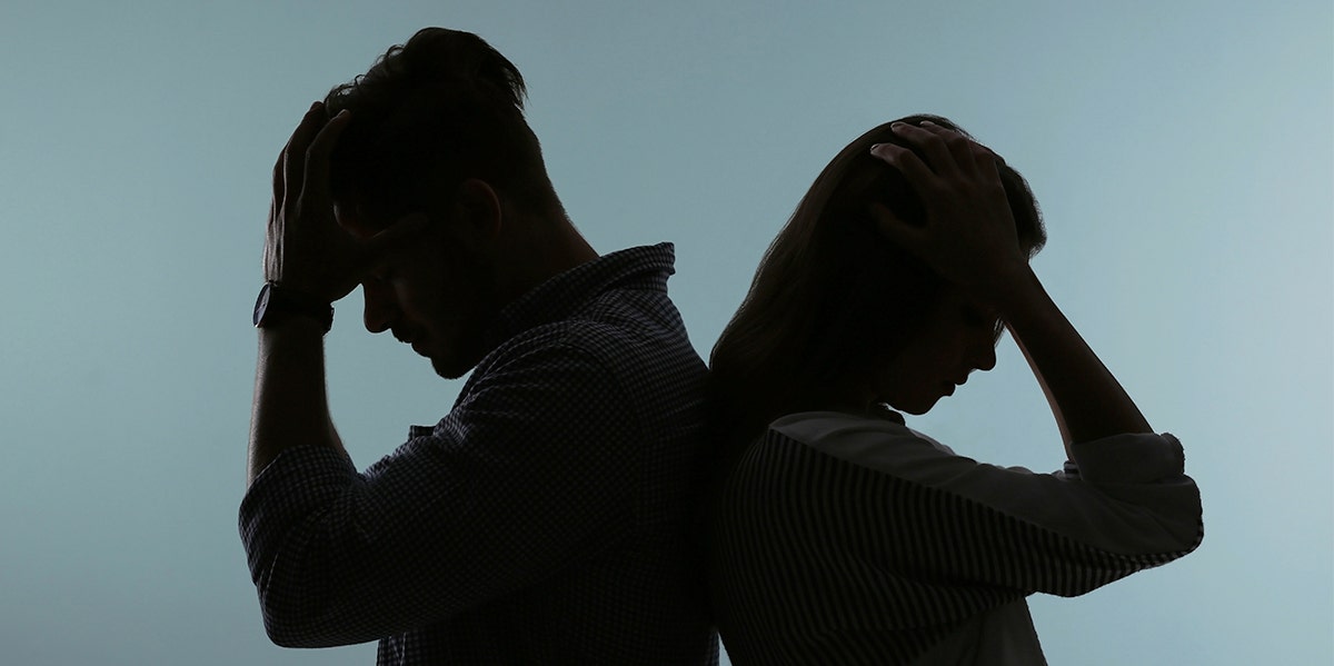 When To Break Up: 10 Signs It's Time To Let Go Of Your Relationship couple facing away from each other dark background
