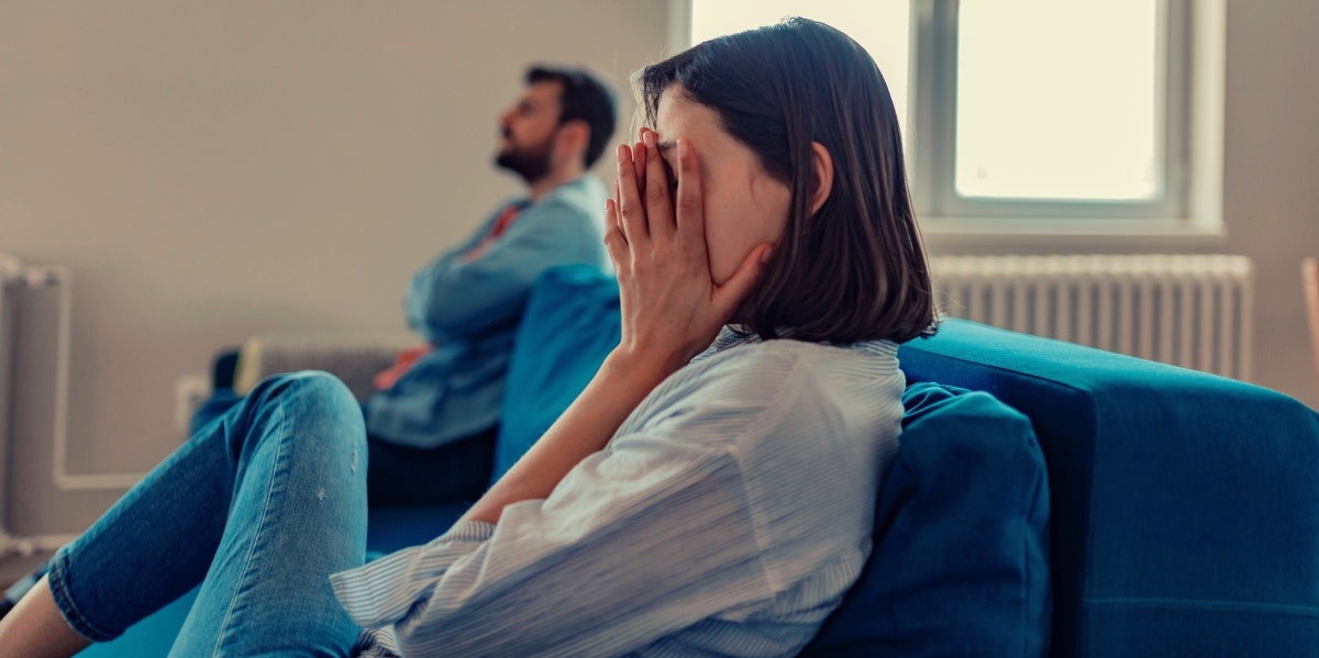 heartbroken woman on couch with man