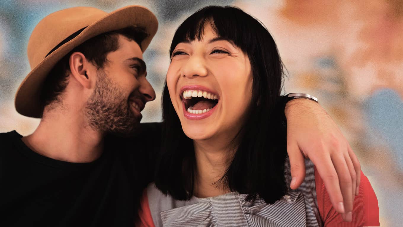 man whispering in woman's ear as she smiles