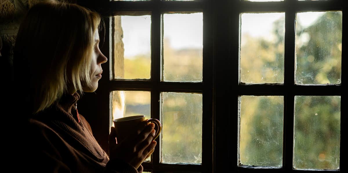 woman looking out window