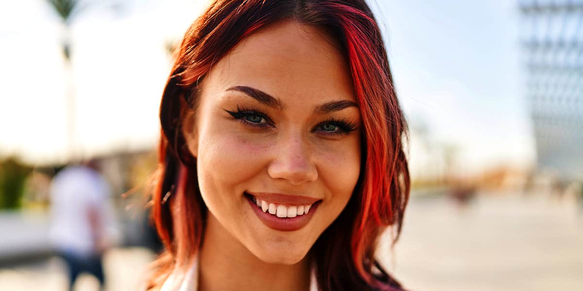 woman with red hair smiling 