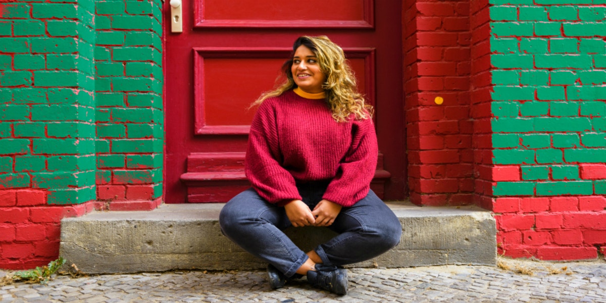 woman sitting outside in sweater