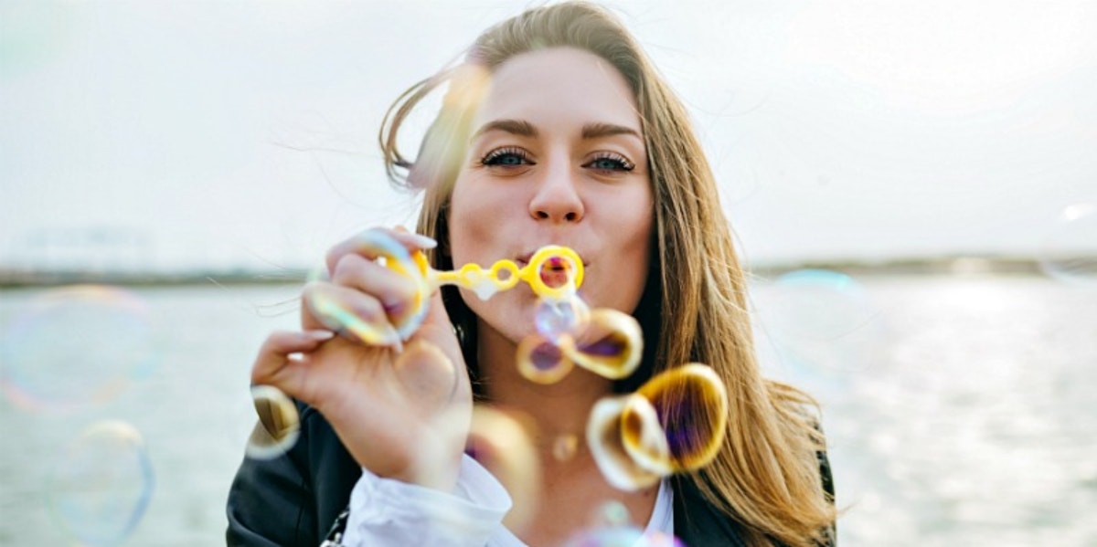 woman blowing bubbles