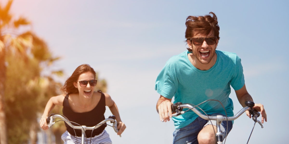 Whole body wellness and healthy living couple riding bikes
