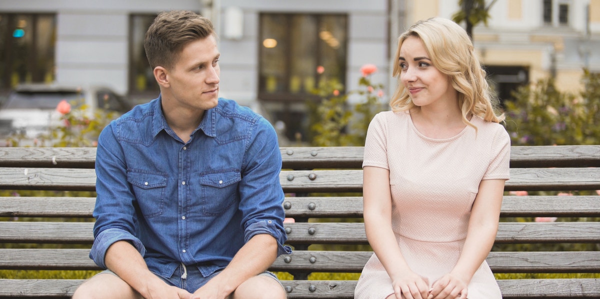 man and woman sitting on bench 