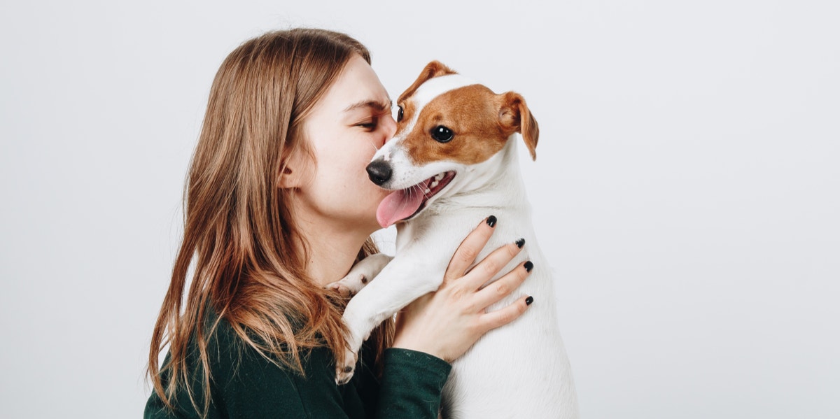 The Main Personality Difference Between Dog People And Cat People woman holding dog