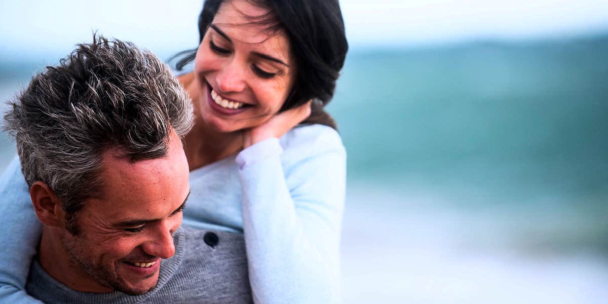 couple playing around on the beach