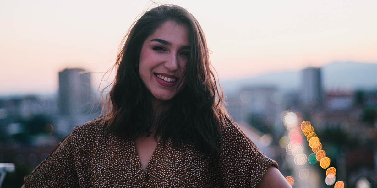 smiling woman overlooking city