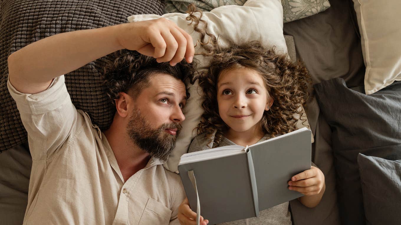 Dad and daughter reading book